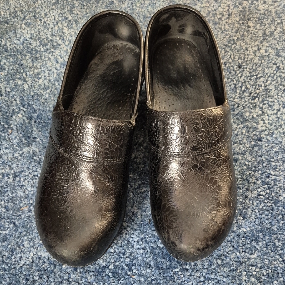 Dansko Black Floral Embossed Clogs